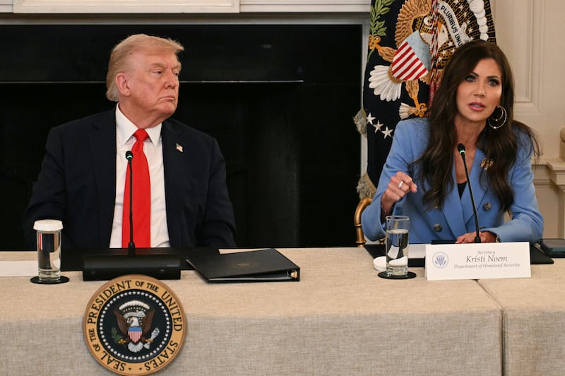 President Donald Trump with then Homeland Security Secretary Kristi Noem speak during a roundtable on October 8, 2025.