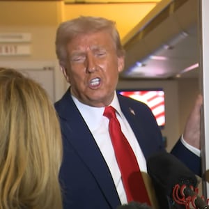 Donald Trump speaks to reporters on Air Force One.