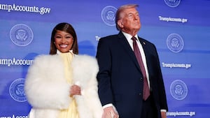 U.S. President Donald Trump and musician Nicki Minaj hold hands onstage at the U.S. Treasury Department's Trump Accounts Summit