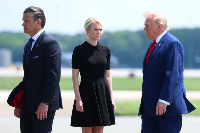 DOVER, DELAWARE - JULY 22: (L-R) U.S. Secretary of War Pete Hegseth, executive assistant to U.S. President Donald Trump Natalie Harp and U.S. President Donald Trump attend a dignified transfer at Dover Air Force Base on July 22, 2026 in Dover, Delaware. President Trump is attending the dignified transfers of Army 1st Lt. Tyler James Feehan, Army Staff Sgt. Michael Emmanuel Swinton, Army Sgt. Angel S. Rampersad and Army Pvt. Isabella Gonzales who were killed in action in Iraq and Jordan. (Photo by Kevin Dietsch/Getty Images)