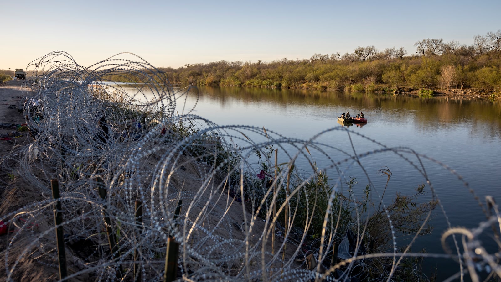 U.S. National Guard soldiers stop to talk while patrolling the Rio Grande at the U.S.-Mexico border