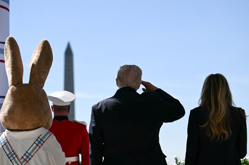 U.S. President Donald Trump and First Lady Melania Trump stand next to a costumed Easter bunny, as they address the crowd during the annual Easter Egg Roll on the South Lawn of the White House, D.C., U.S., April 6, 2026. BRENDAN SMIALOWSKI/Pool via REUTERS