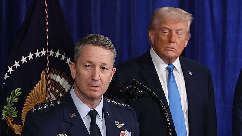 President Donald Trump with his eyes closed as Chairman of the Joint Chiefs of Staff Dan Caine speaks during a press conference at Mar-a-Lago club on January 03, 2026, in Palm Beach, Florida.