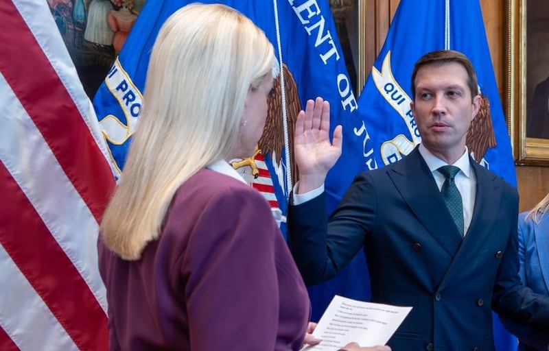 Patrick Davis getting sworn in as the assistant attorney general for legislative affairs by former Attorney General Pam Bondi.