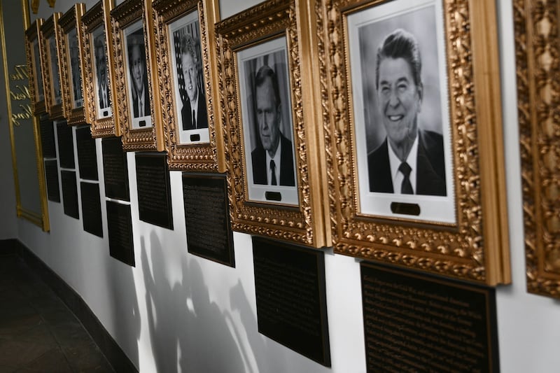 Portraits with new plaques of explanatory text are seen on the Presidential Walk of Fame on the Colonnade of the White House in Washington, DC, on December 17, 2025.