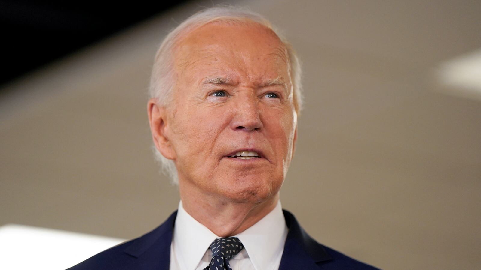 Joe Biden stares forward while he speaks at an event.