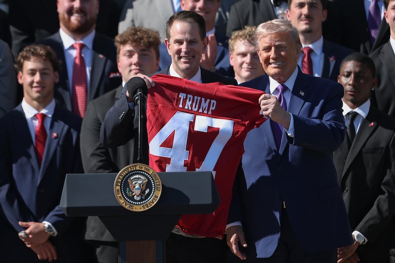 WASHINGTON, DC - MAY 11: Head Coach Curt Cignetti presents U.S. President Donald Trump with a football jersey as Trump hosts an event to celebrate the 2026 Football National Champion Indiana Hoosiers football team on the South Lawn of the White House on May 11, 2026 in Washington, DC. The Indiana Hoosiers defeated the Miami Hurricanes 27-21 to win their first-ever College Football Playoff National Championship on January 19, 2026. (Photo by Kevin Dietsch/Getty Images)