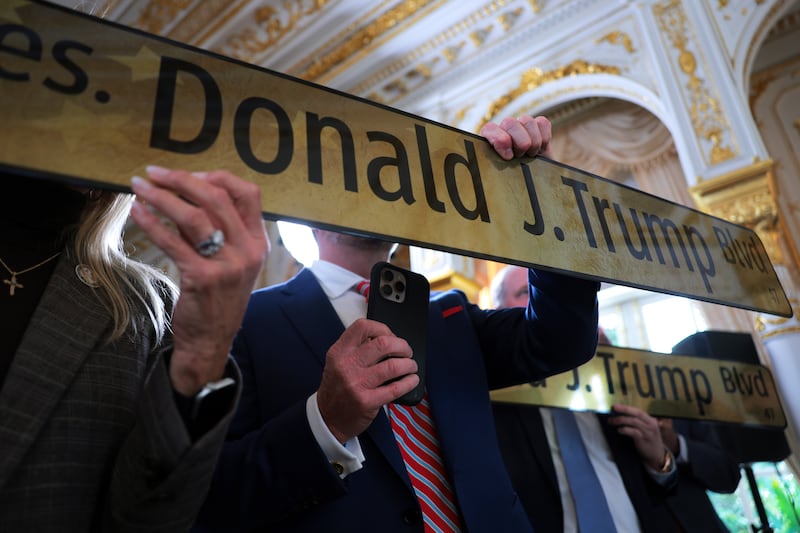 A golden street sign that reads "Donald J. Trump Blvd" is displayed during a Road Dedication Ceremony at Mar-a-Lago on January 16, 2026 in Palm Beach, Florida. Florida State lawmakers approved the name change of a portion of Southern Boulevard to “President Donald J. Trump Boulevard.”