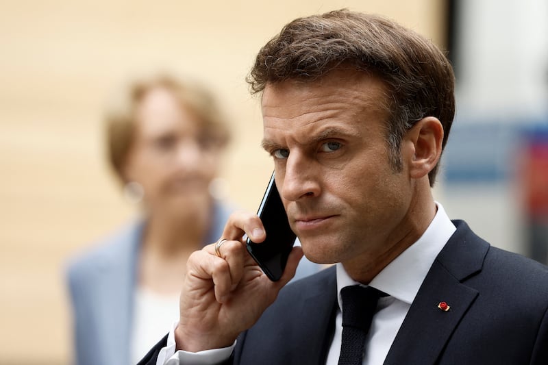 French President Emmanuel Macron talks on the phone as he arrives for a news conference, following the G7 summit at Schloss Elmau castle, near Garmisch-Partenkirchen, Germany, June 28, 2022. REUTERS/Benoit Tessier