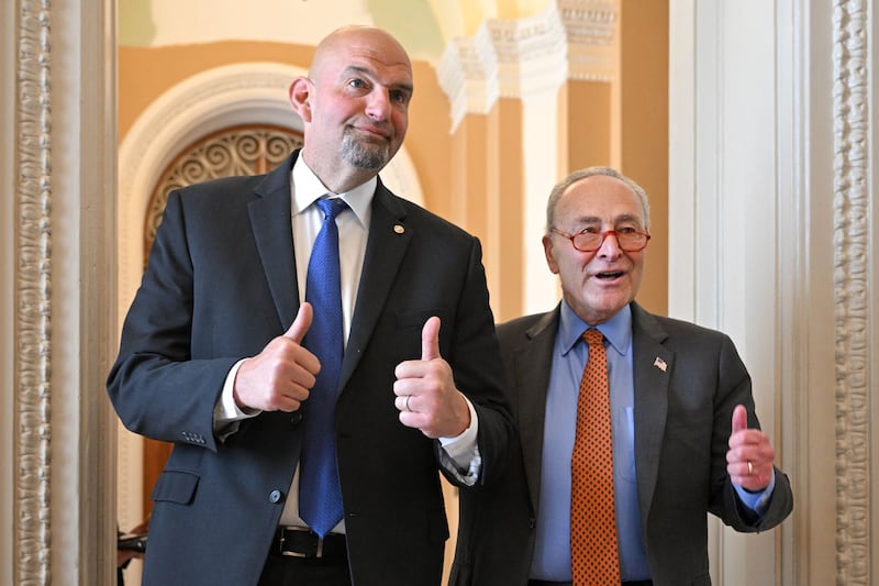Senate Majority Leader Chuck Schumer (R), D-NY, and Senator John Fetterman (D-PA) walk to a luncheon after meeting in Schumer's office at the U.S. Capitol in 2023.