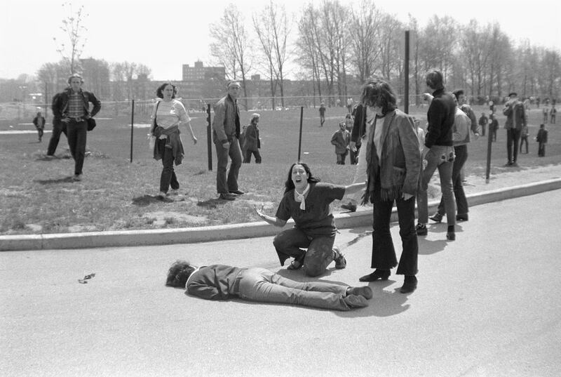 A young protester, her face anguished, kneeling by the body of a slain student.