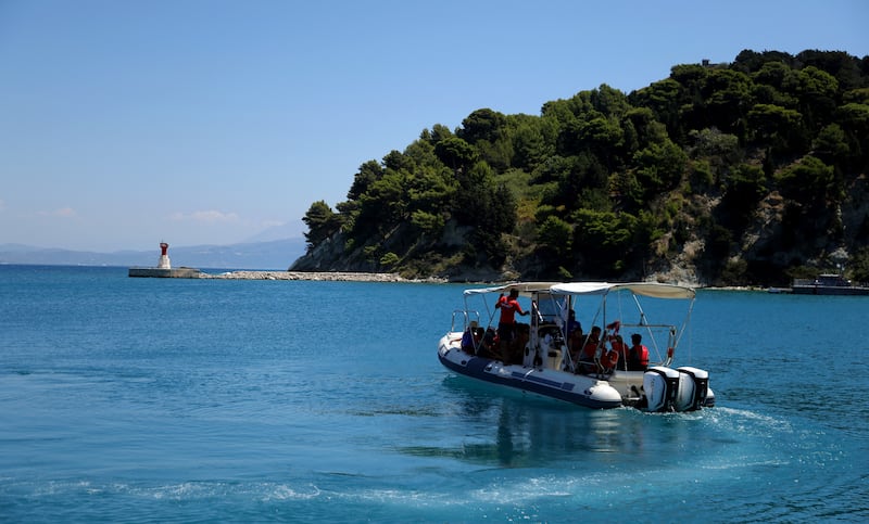 Tourists take a pleasure boat ride on the island of Sazan, near the Albanian city of Vlore, on Mediterranean coast, on July 30 2024. Ivanka Trump and her husband Jared Kushner want to transform Albania's largest island, and former Cold War Military base built by Albania's former communist rulers. The daughter of former US President want luxury villas to go up on the island of Sazan that for decades served as a garrison with bunkers, fallout shelters and a warren of tunnels designed to withstand a nuclear attack. (Photo by ADNAN BECI / AFP) (Photo by ADNAN BECI/AFP via Getty Images)