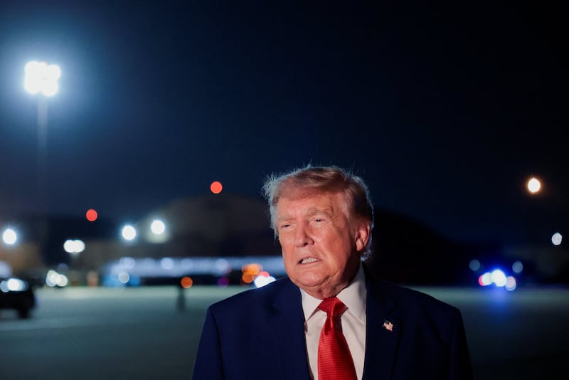 U.S. President Donald Trump speaks to members of the media after disembarking Air Force One at Joint Base Andrews, Maryland, U.S., August 11, 2026.