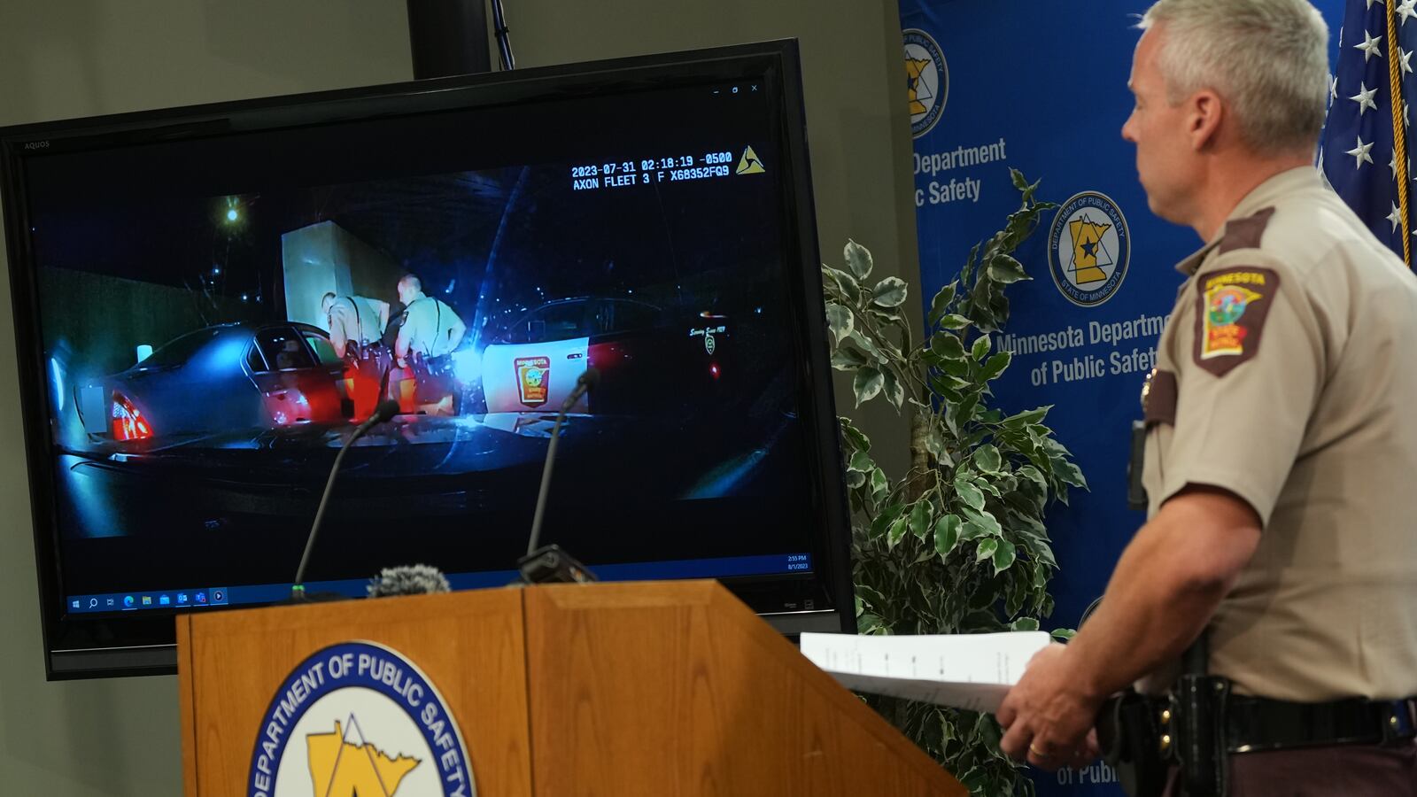 Minnesota State Patrol Colonel Matt Langer stands by as bodycam and dash cam footage of the police shooting death of Ricky Cobb II plays at a press conference