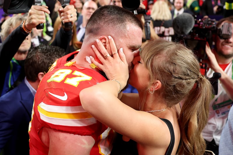 Travis Kelce of the Kansas City Chiefs kisses Taylor Swift after defeating the San Francisco 49ers 25-22 in overtime during Super Bowl LVIII at Allegiant Stadium on February 11, 2024