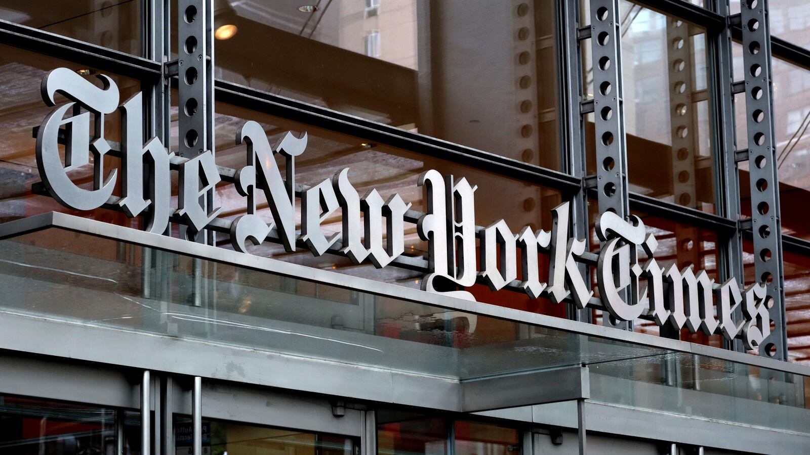 The New York Times logo hangs above a doorway of their corporate headquarters in New York City. The union representing Times’ employees has accused the newspaper of violating its union contract in its decision to eliminate the sports desk.