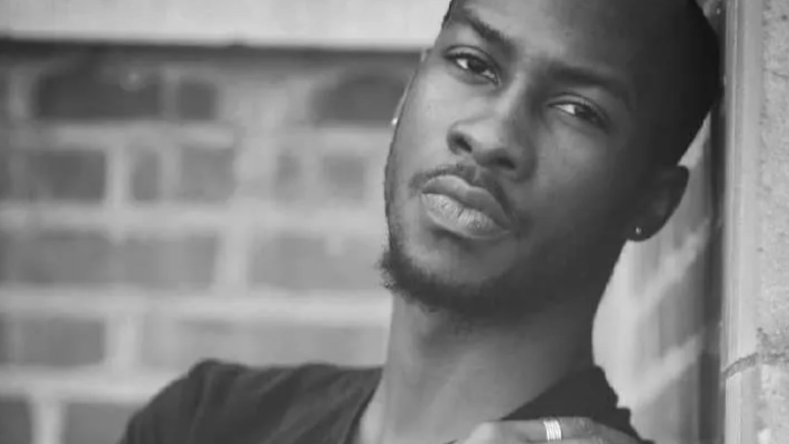 A black-and-white photo of O’Shae Sibley staring forward.