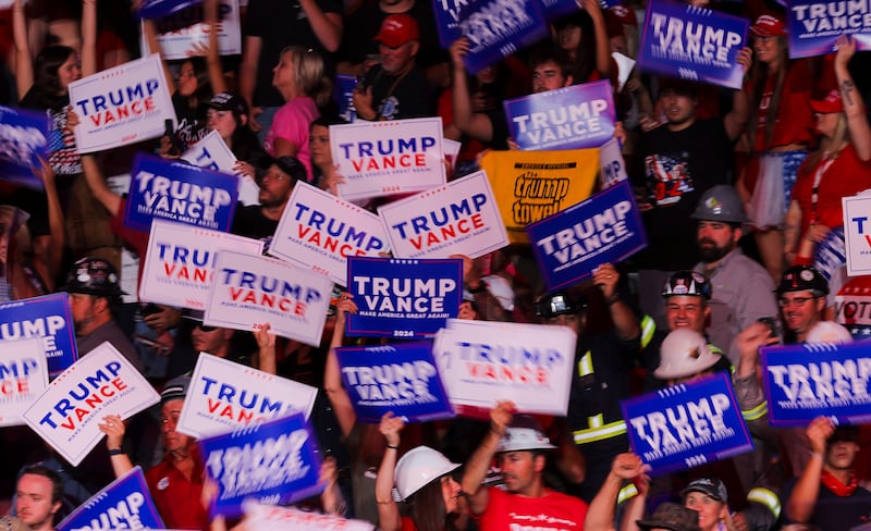 People display Trump campaign signs as they attend the campaign rally of Republican presidential nominee and former U.S. President Donald Trump in Indiana, Pennsylvania, U.S., September 23, 2024.
