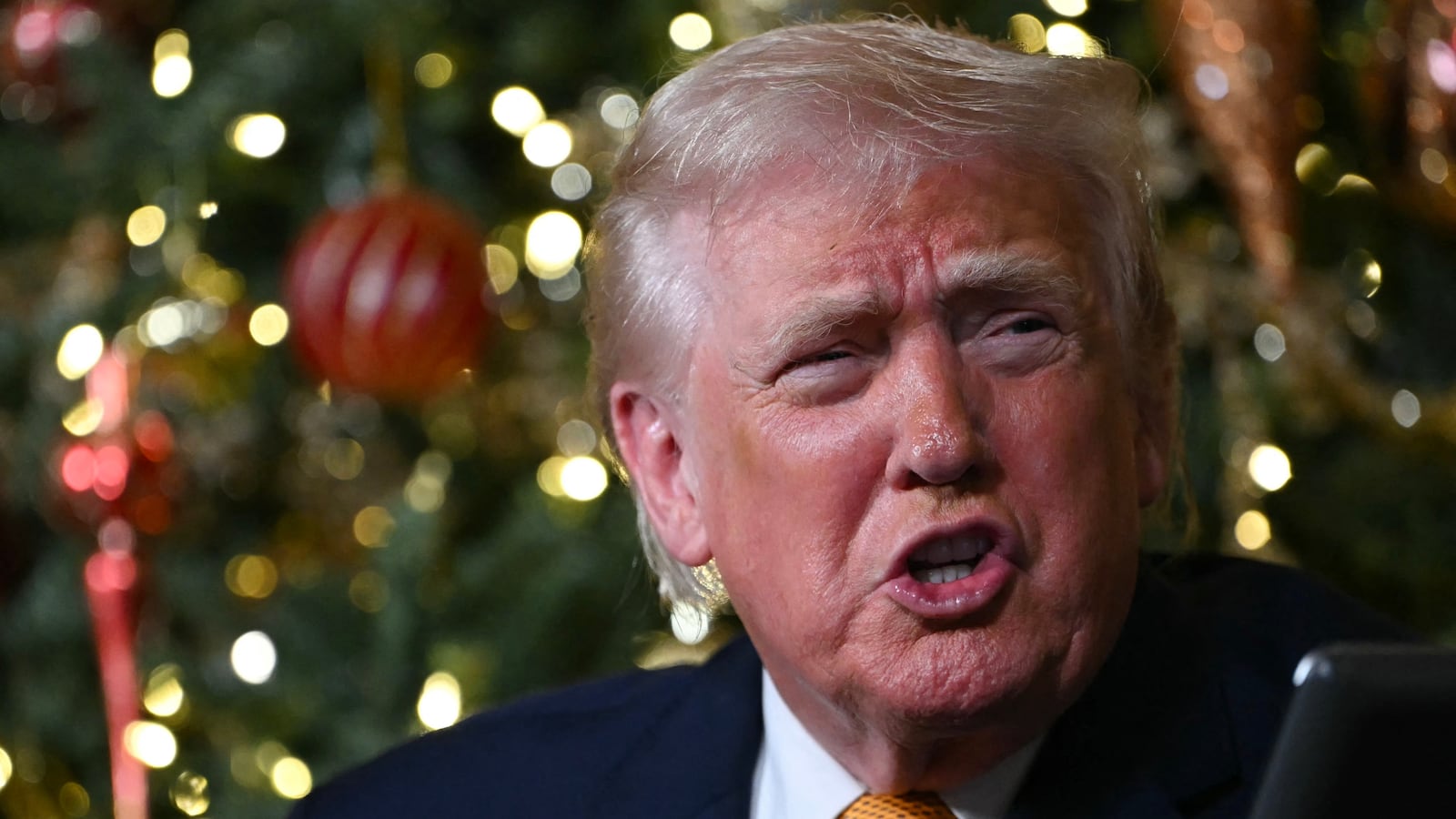US President Donald Trump participates in NORAD Santa tracker phone calls, on Christmas Eve, from the Mar-a-lago club in Palm Beach, Florida, on December 24, 2025. (Photo by ANDREW CABALLERO-REYNOLDS / AFP via Getty Images)