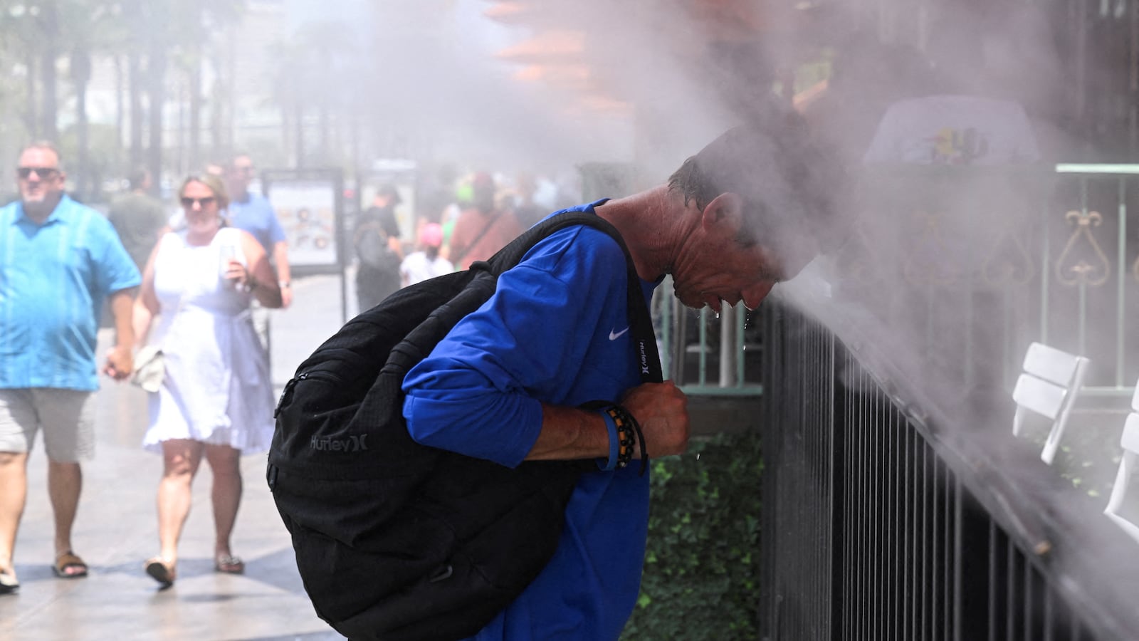 Robert A. places his head in the misters during an excessive heat warning in Las Vegas, Nevada.