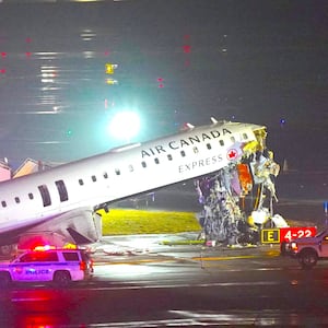 Emergency crews work around an Air Canada Express jet that had collided with a ground vehicle at New York's LaGuardia Airport in Queens, New York, U.S. March 23, 2026.