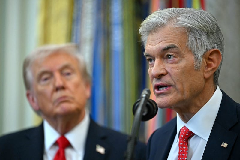 US President Donald Trump listens to Medicare and Medicaid Administrator nominee Mehmet Oz speak during an announcement in the Oval Office of the White House in Washington, DC, on October 16, 2025. (Photo by ANDREW CABALLERO-REYNOLDS / AFP) (Photo by ANDREW CABALLERO-REYNOLDS/AFP via Getty Images)