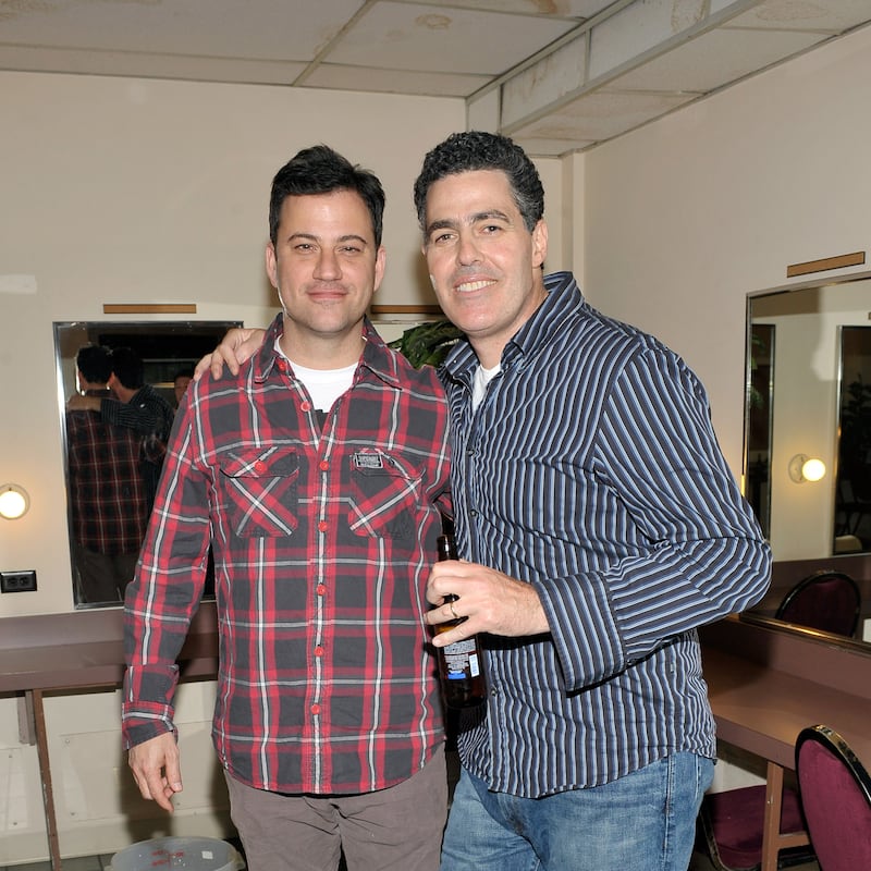 Comedians Jimmy Kimmel helps Adam Carolla celebrate the release of his new paperback book "In Fifty Years We'll All Be Chicks" on May 21, 2011 in Los Angeles, California. (Photo by John M. Heller/WireImage)