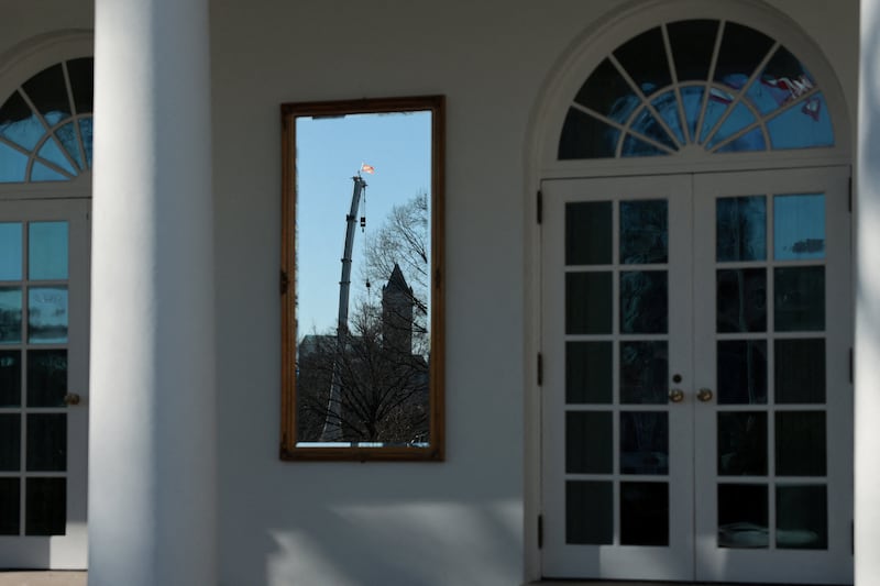 A construction crane from the White House ballroom work site is reflected in one of the mirrors U.S. President Donald Trump has installed on West Wing colonnade, at the White House, in Washington, D.C., U.S., January 13, 2026.