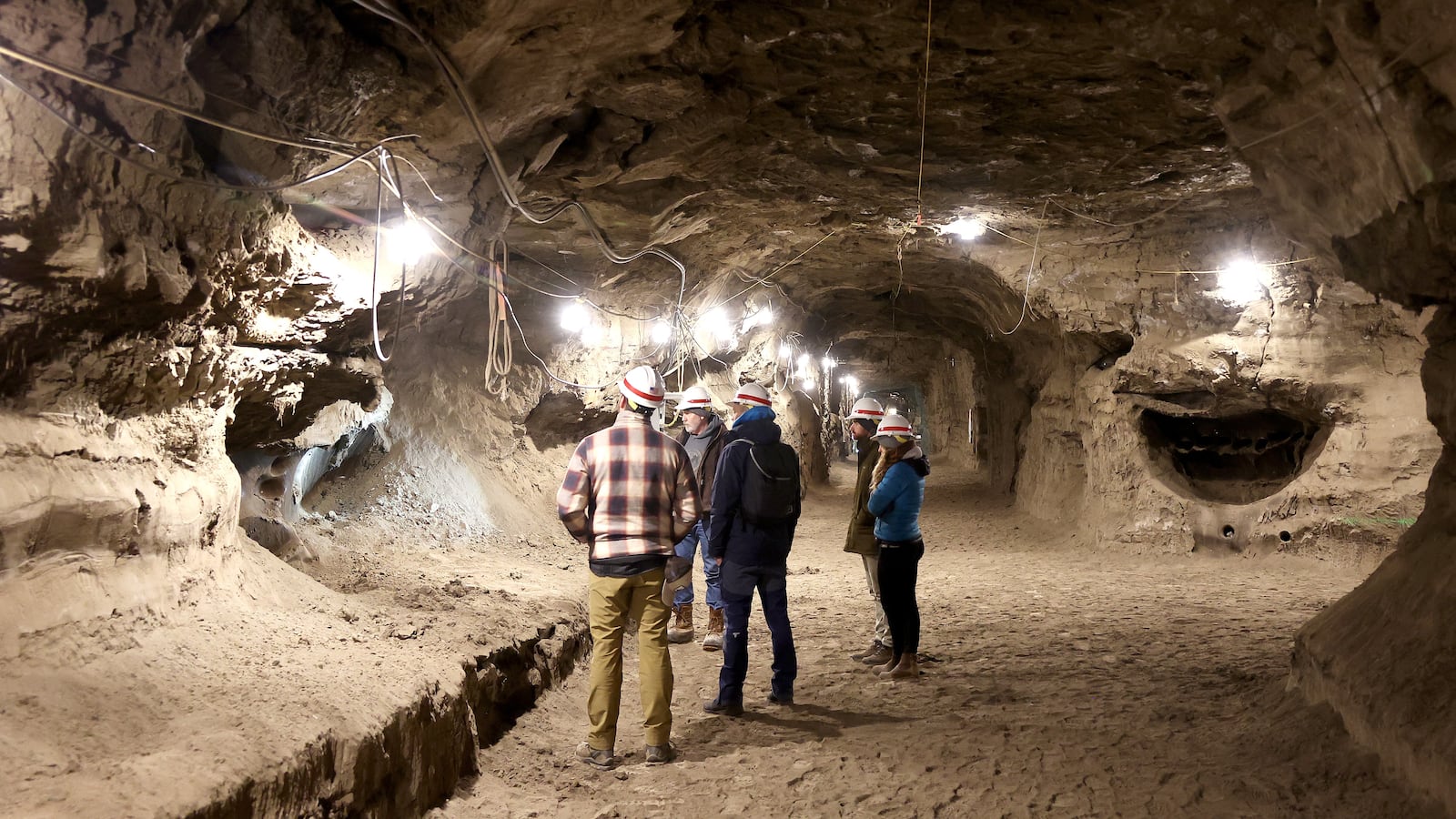 NASA SnowEx campaign researchers and pilots tour the Permafrost Tunnel Research Facility near Fairbanks, Alaska, in May 2023.