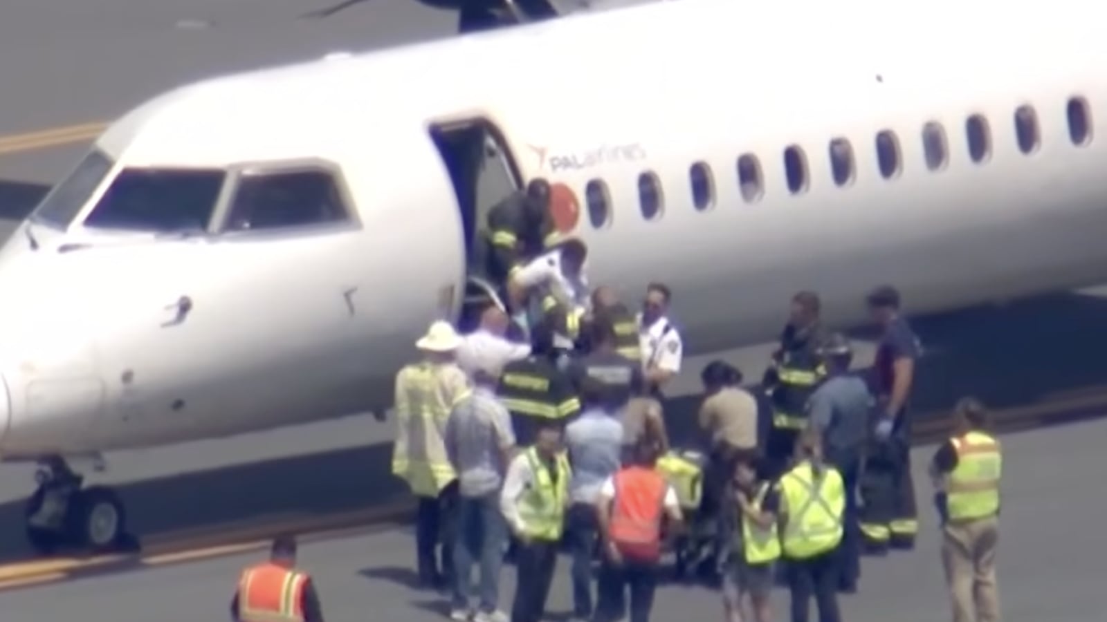Passengers and pilot disembarking from the plane.