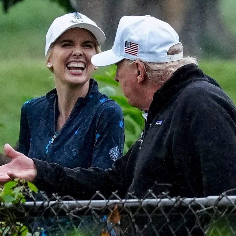 U.S. Interior Secretary Doug Burgum and Executive assistant to U.S. President Donald Trump Natalie Harp speak with Donald Trump during a visit at a golf course at Hains Point in Washington, D.C., U.S., June 28, 2026.