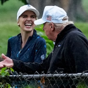U.S. Interior Secretary Doug Burgum and Executive assistant to U.S. President Donald Trump Natalie Harp speak with Donald Trump during a visit at a golf course at Hains Point in Washington, D.C., U.S., June 28, 2026.