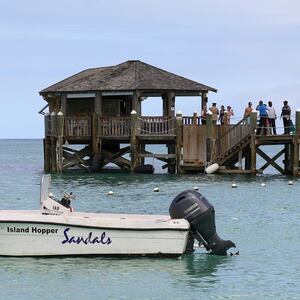 People gather on the resort pier after what police described as a fatal shark attack against a tourist at Sandals Royal Bahamian resort, in Nassau, Bahamas December 4, 2023.  