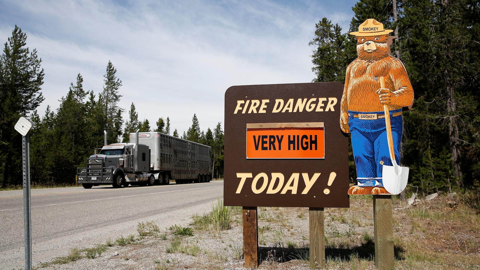 A forest service High Fire danger sign is seen next to Highway 191 in West Yellowstone, Montana.
