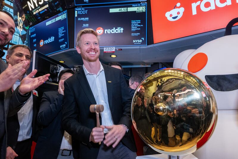 Reddit CEO Steve Huffman stands on the floor of the New York Stock Exchange after ringing a bell on the floor to set the app's share price in March 2024.
