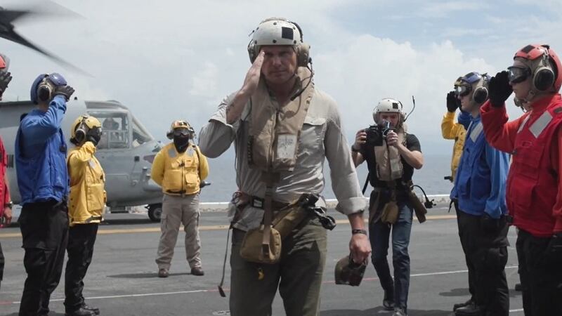 Pete Hegseth salutes aboard the USS Iwo Jima.