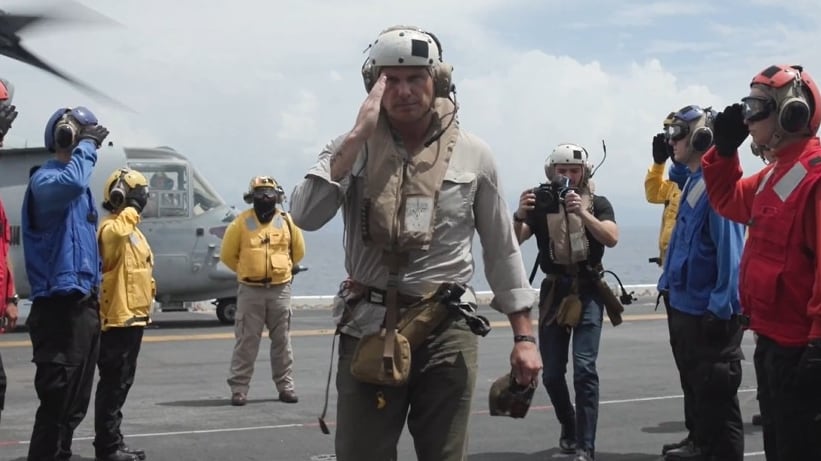 Pete Hegseth salutes aboard the USS Iwo Jima.