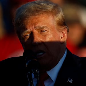 A shadow is cast across Republican presidential nominee, former President Donald Trump as he addresses a campaign rally at the Butler Farm Show grounds on October 05, 2024 in Butler, Pennsylvania.
