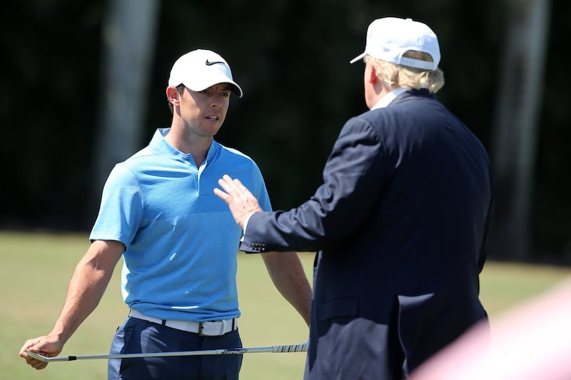 Republican presidential candidate Donald Trump makes an appearance prior to the start of play and speaks with golfer Rory McIlroy of Northern Ireland during the final round of the World Golf Championships-Cadillac Championship at Trump National Doral Blue Monster Course  on March 6, 2016 in Doral, Florida.
