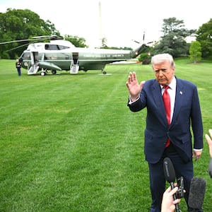 US President Donald Trump speaks to journalists as he makes his way to board Marine One