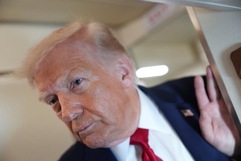 FILE PHOTO: File Photo: U.S. President Donald Trump looks on as he speaks to members of the media on board Air Force One while flying from Joint Base Andrews to Chippewa Valley Regional Airport in Eau Claire, Wisconsin, U.S., June 5, 2026. REUTERS/Nathan Howard/File Photo/File Photo