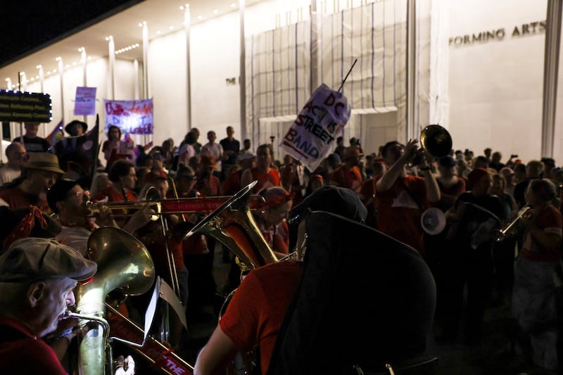People attend a protest to denounce the Kennedy Center board's vote to close one of the nation's premier performing arts venues, outside the John F. Kennedy Memorial Center for the Performing Arts in Washington, D.C.,