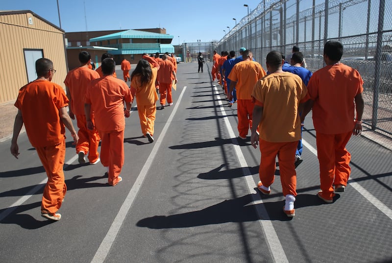 FLORENCE, AZ - FEBRUARY 28: Immigrant detainees walk through the Immigration and Customs Enforcement (ICE), detention facility on February 28, 2013 in Florence, Arizona. With the possibility of federal budget sequestration, ICE released 303 immigration detainees in the last week from detention facilities throughout Arizona. More than 2,000 immigration detainees remain in ICE custody in the state. Most detainees typically remain in custody for several weeks before they are deported to their home country, while others remain for longer periods while their immigration cases work through the courts. (Photo by John Moore/Getty Images)