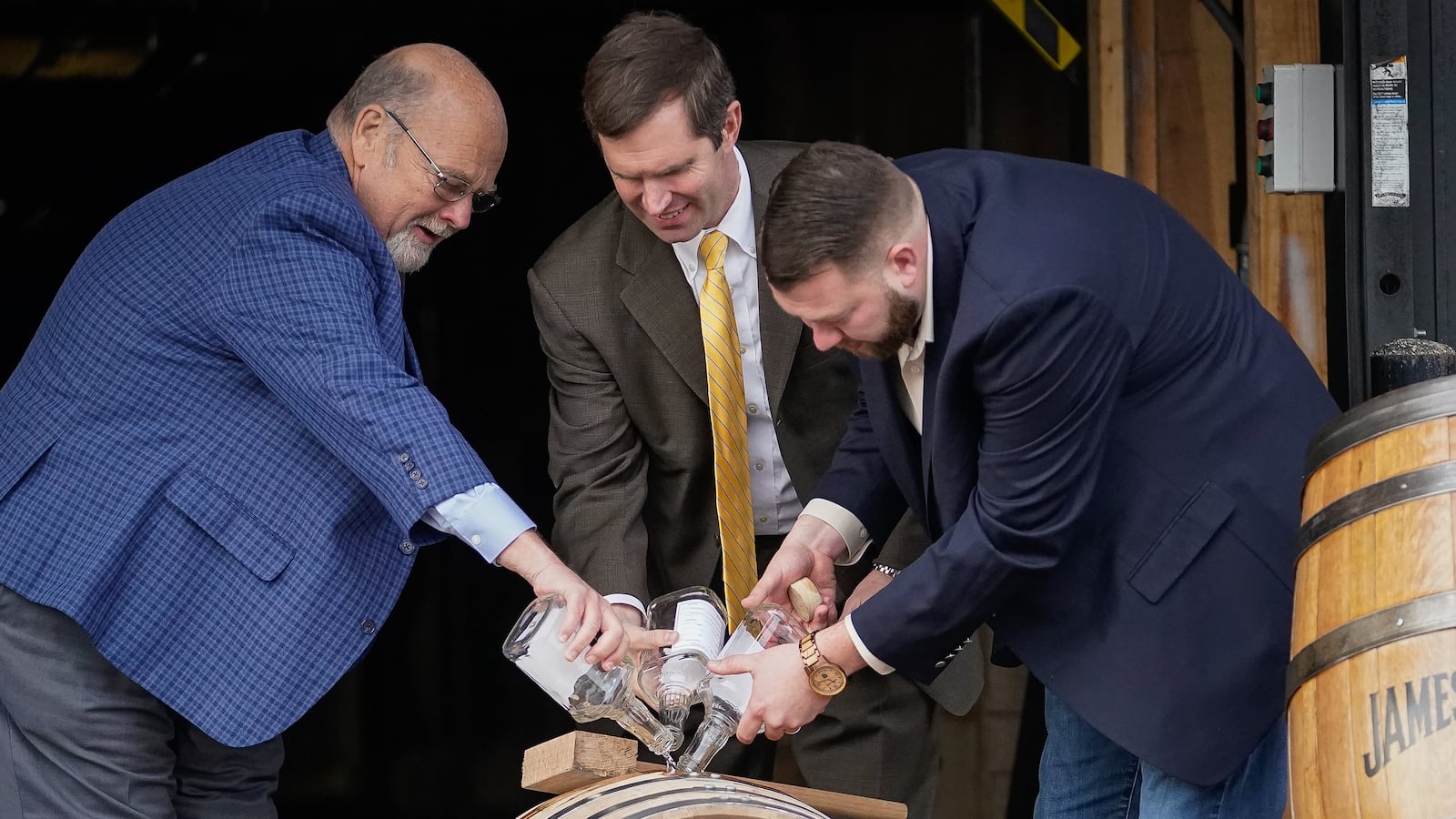 CLERMONT, KY - FEBRUARY 17: Jim Beam Master Distiller Fred Noe (L), Kentucky Gov. Andy Beshear (C) and Freddie Now, Beam Distiller, fill the distillery's 16 millionth barrel of bourbon at the Jim Beam Distillery on February 17, 2020 in Clermont, Kentucky. U.S. whiskey exports have fallen by 27 percent to the European Union, the product's largest export market, caused by retaliatory tariffs imposed by the 27-nation alliance, a trade group said last week. (Photo by Bryan Woolston/Getty Images)