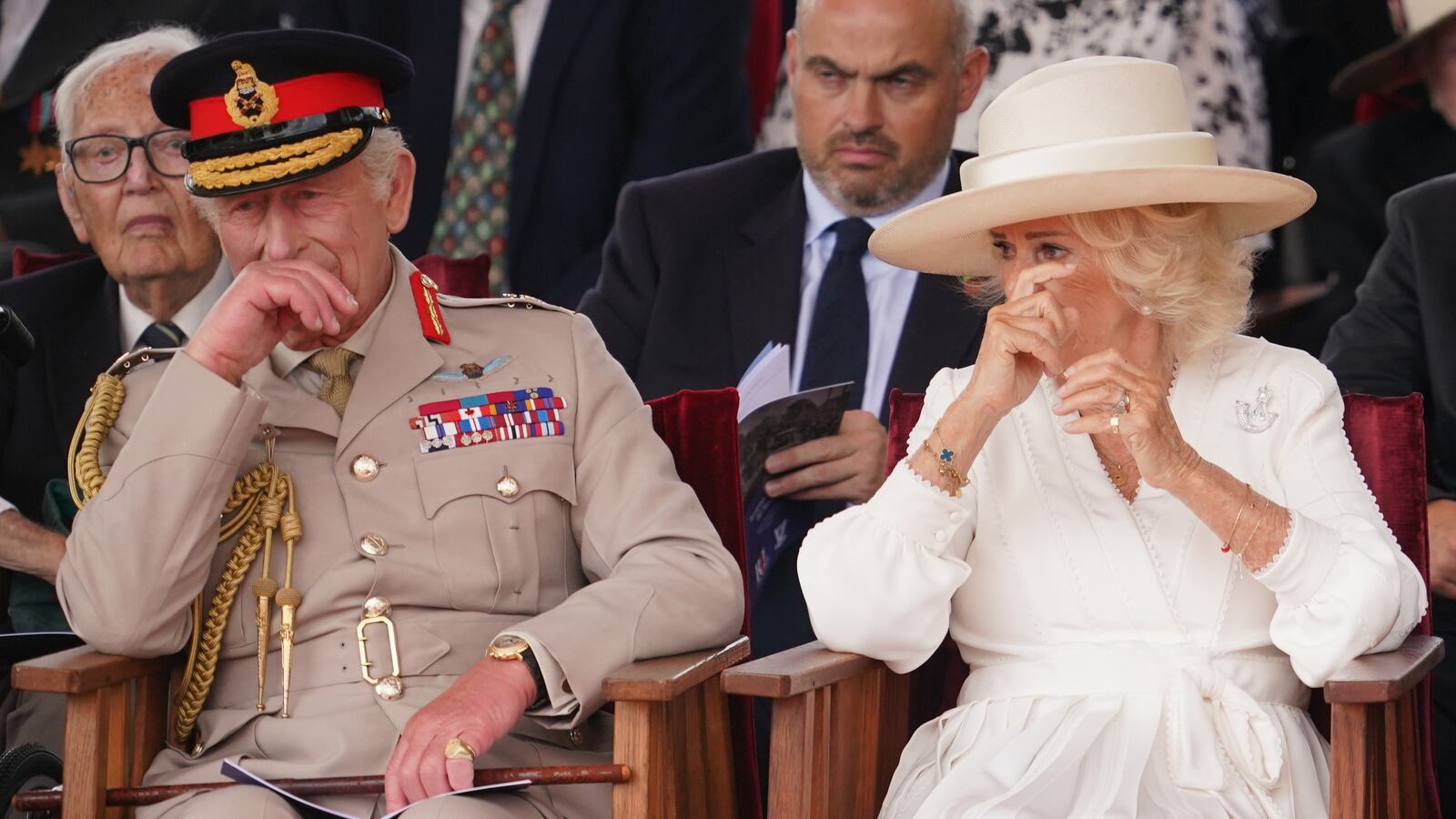 King Charles III and Queen Camilla react emotionally as they attend a Service of Remembrance to commemorate the 80th Anniversary of VJ Day
