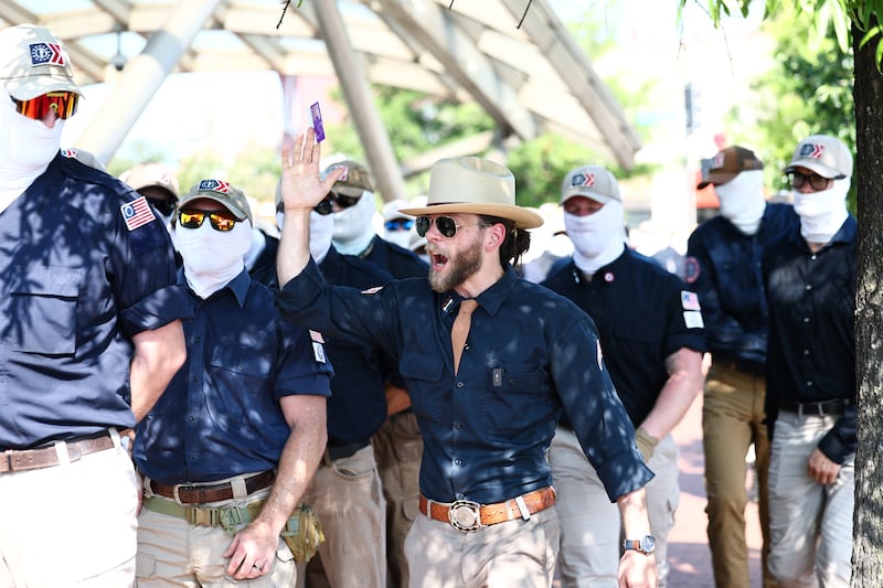 Founder of the white supremacist group Patriot Front Thomas Rousseau (C) and fellow members gather at Eastern Market metro station