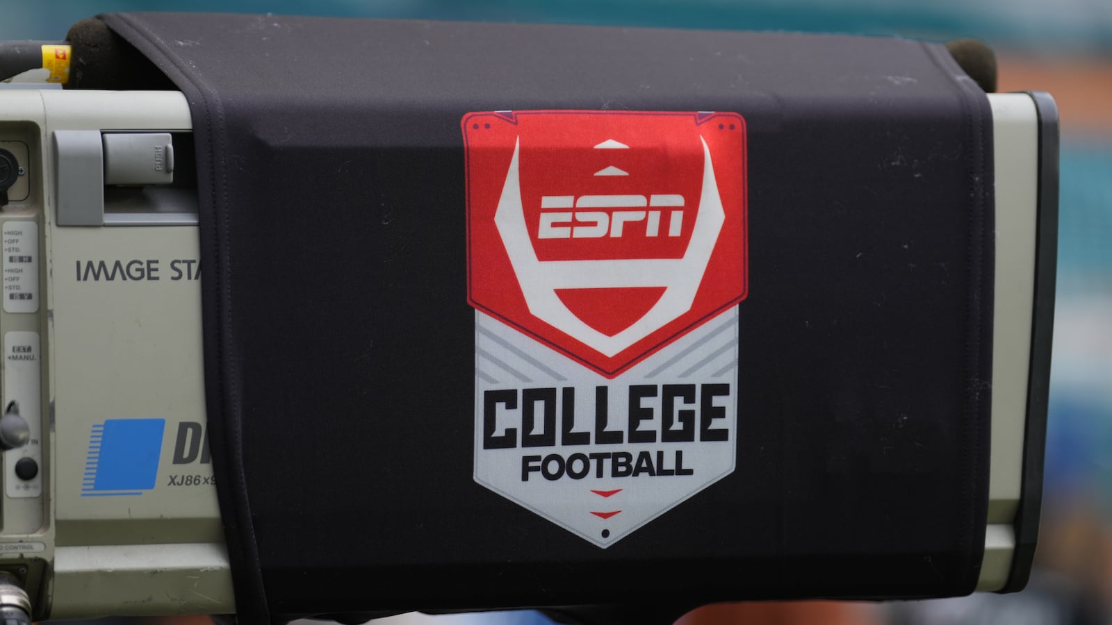 A TV camera draped with an ESPN College Football cover.
