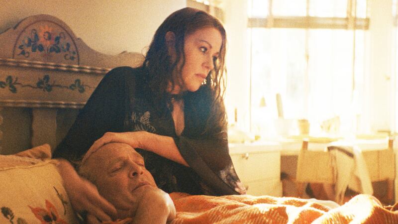 Molly Ringwald holds Tom Hollander in bed in a still from 'Feud: Capote vs the Swans'