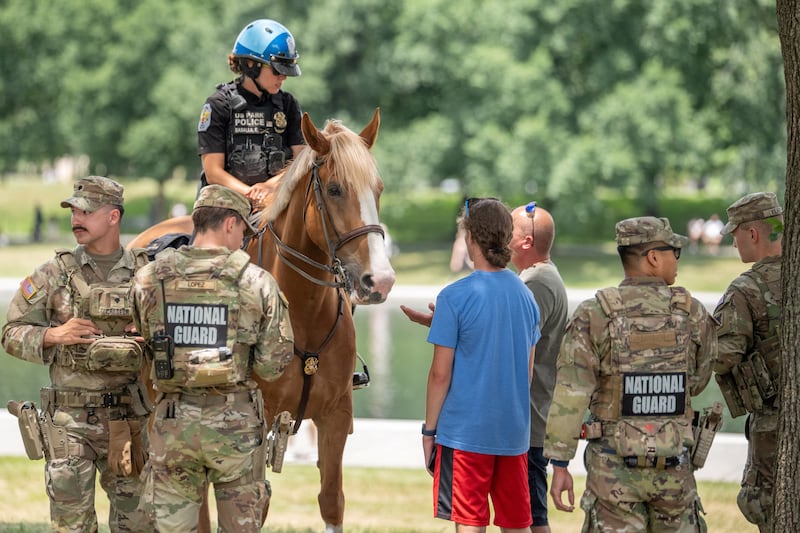 A mounted US Park Police officer writes a citation for 17-year-old for what police said was taking a piece of paint from the Lincoln Memorial Reflecting Pool, after recent renovations following a directive from U.S. President Donald Trump to paint it blue ahead of the 250th anniversary of U.S. Independence, in Washington, D.C., U.S., June 21, 2026.