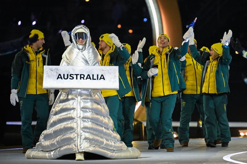 Each country’s athletes were escorted by women wearing hooded silver puffer dresses and ski goggles.